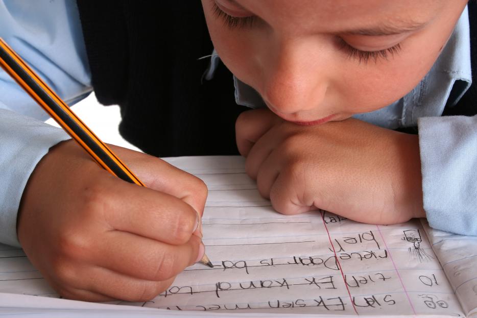 A nursery student practicing handwriting, representing when to apply for nursery schools in London.